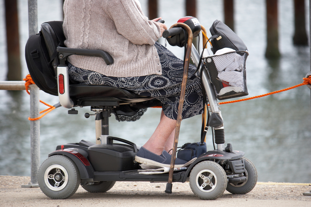 Close up of senior woman on mobility scooter near a dock
