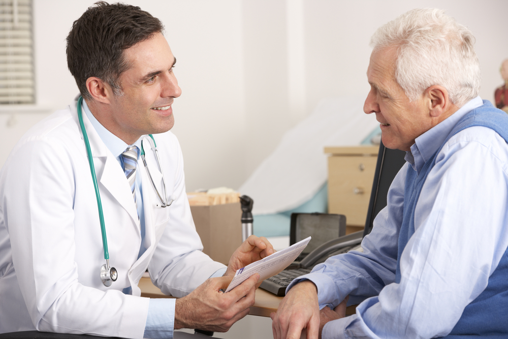 Doctor talking to elderly man about prescription