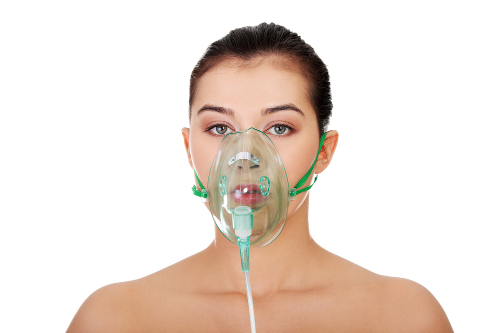 Young woman wearing oxygen mask